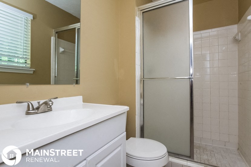 a bathroom with a toilet sink and a shower