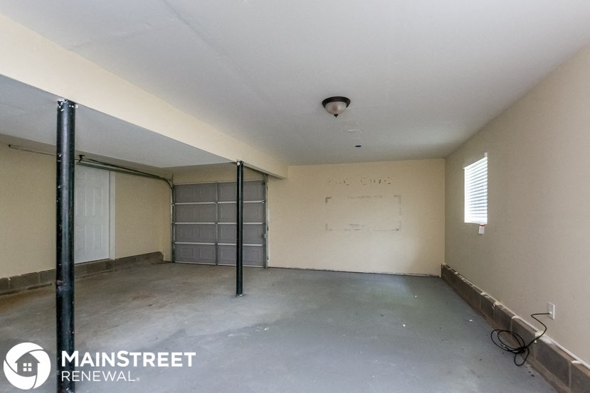 the interior of an empty room with a garage door
