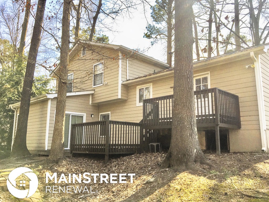 the back of a house with a porch and a deck