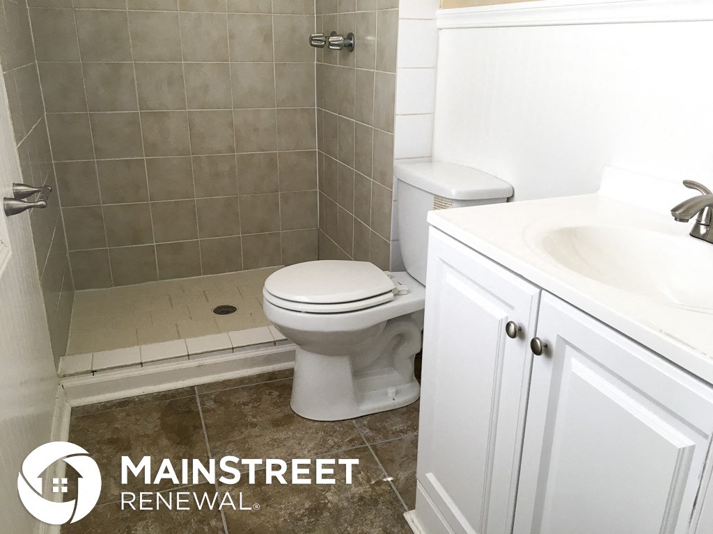 an image of a bathroom with a toilet and a sink