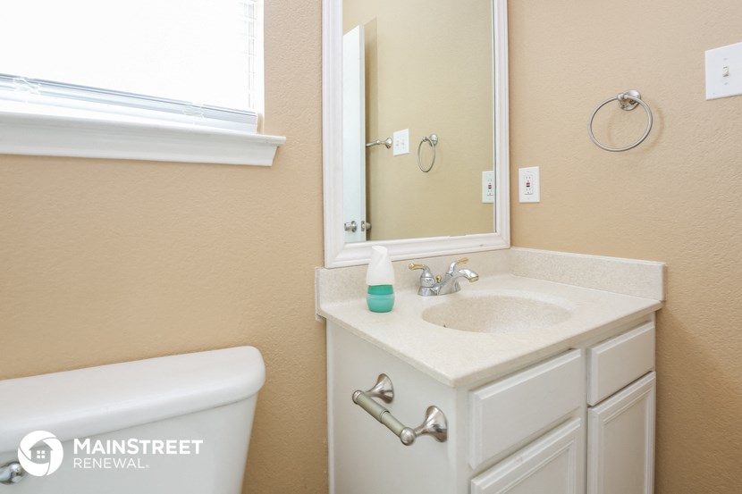 a bathroom with a sink and a mirror and a toilet