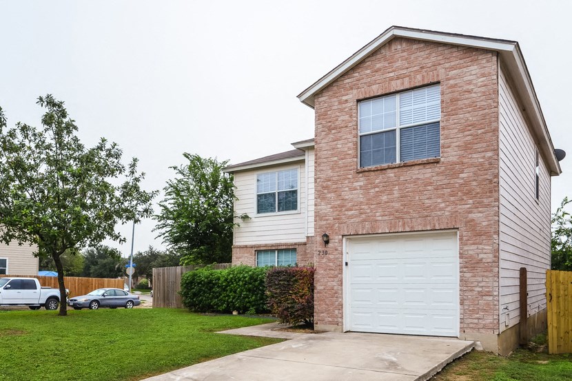 a brick and with a white garage door