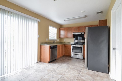 a kitchen with stainless steel appliances and wooden cabinets