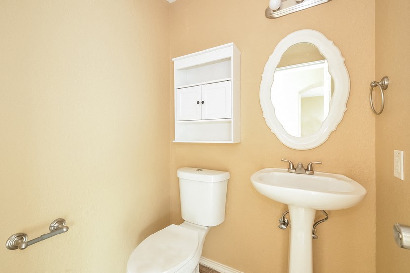 a bathroom with a sink toilet and a mirror