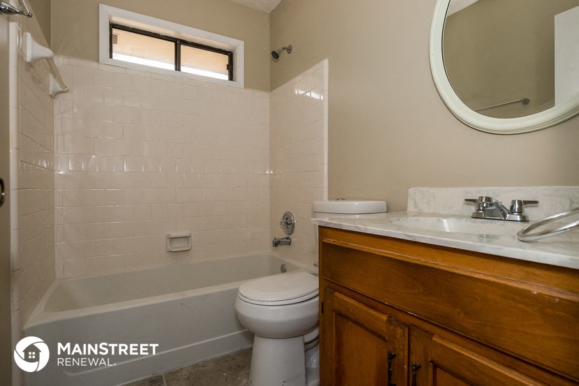 a small bathroom with a toilet sink and tub
