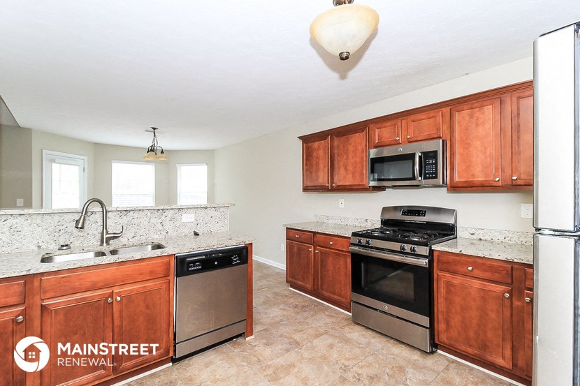a kitchen with wooden cabinets and stainless steel appliances