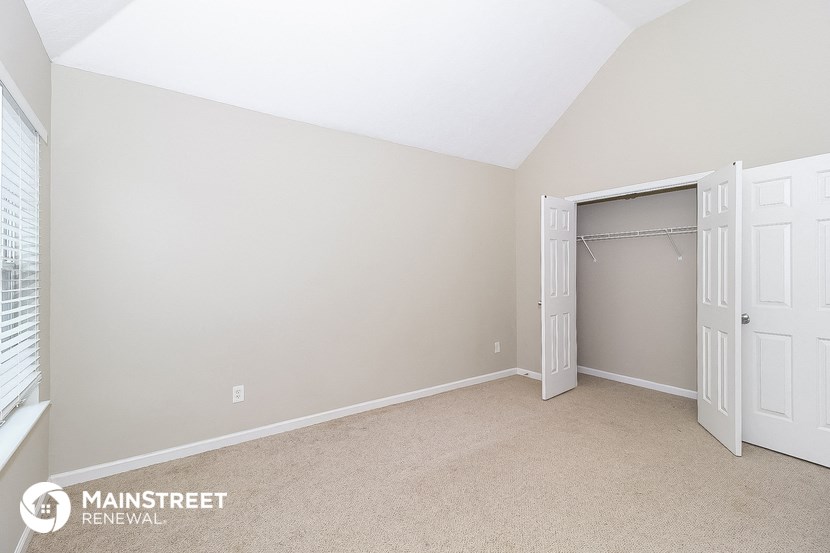 a bedroom with two closets and a door to a closet