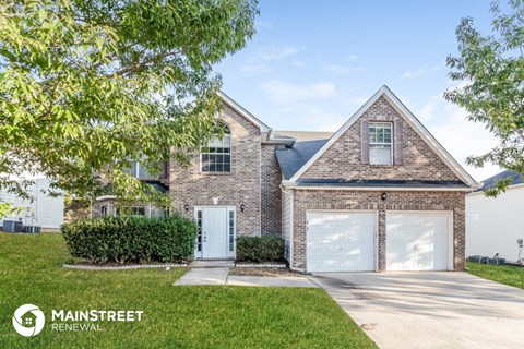 front view of a brick house with two garage doors