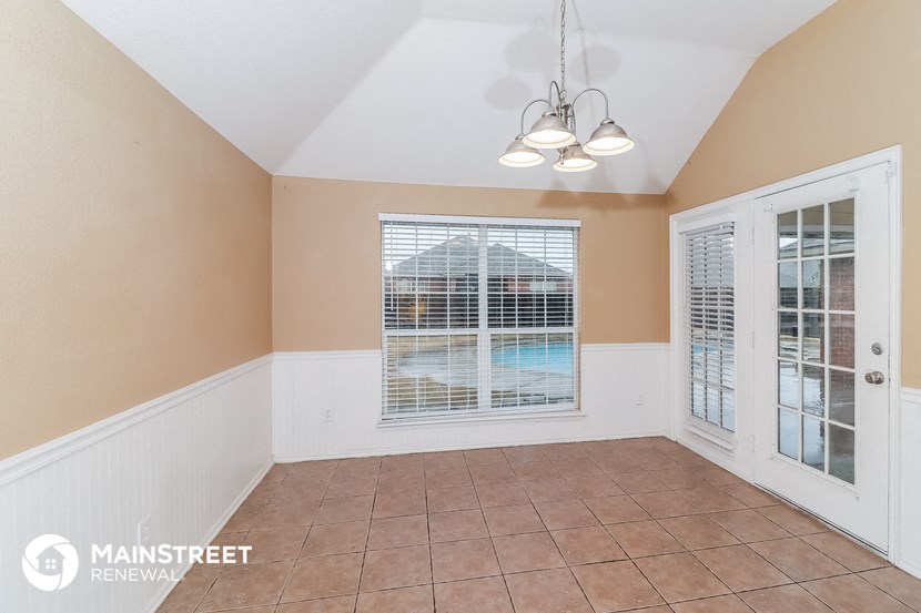 a living room with a large window and a door to a pool