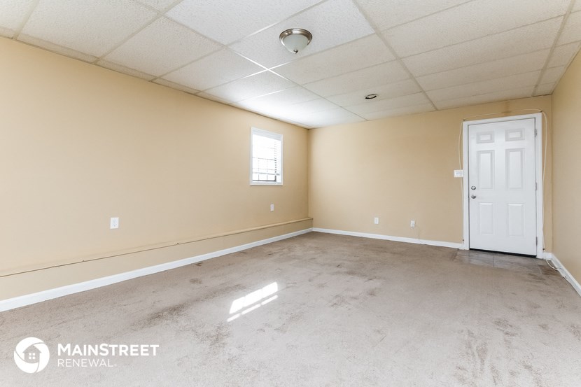 an empty living room with a white door