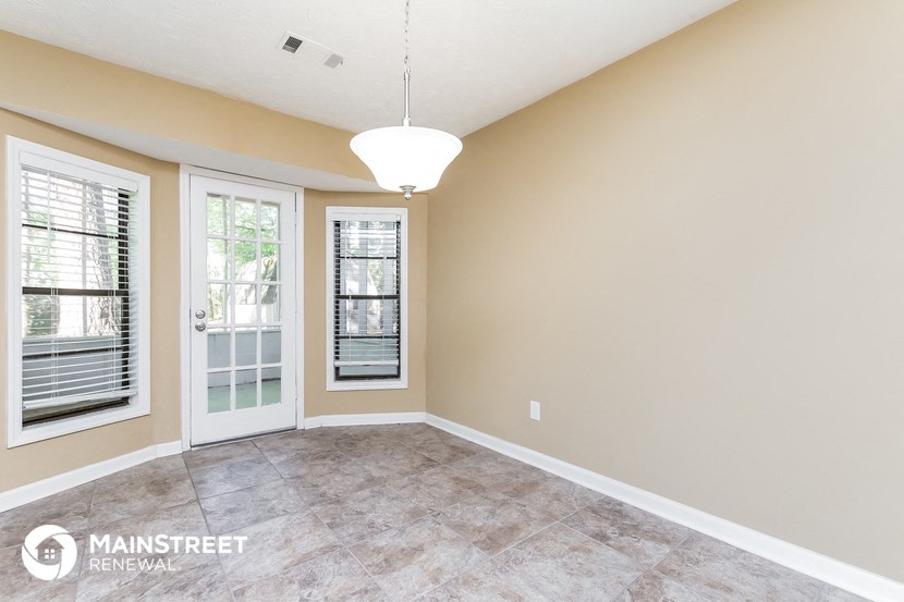 an empty living room with a door to a patio