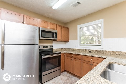 a kitchen with granite counter tops and stainless steel appliances