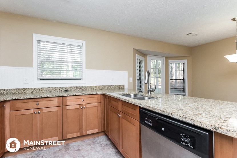 the kitchen has granite counter tops and stainless steel appliances