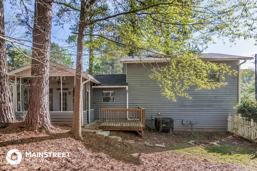 a small house with a wooden bench in front of it