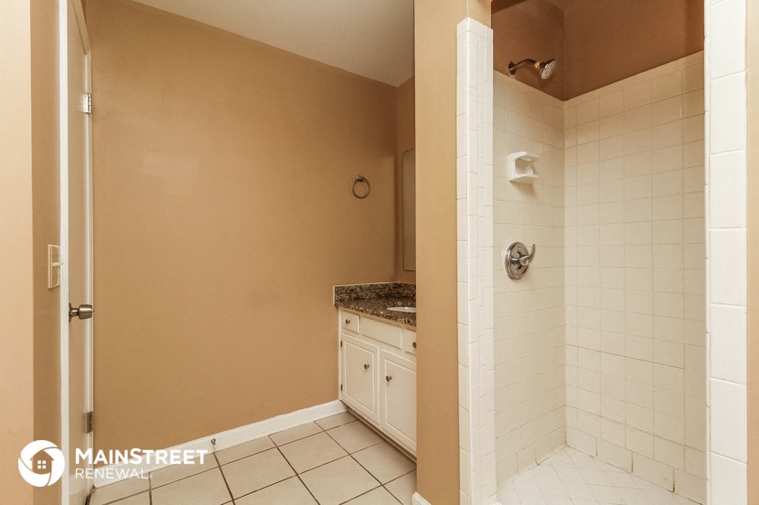 a bathroom with a sink and a toilet and a shower