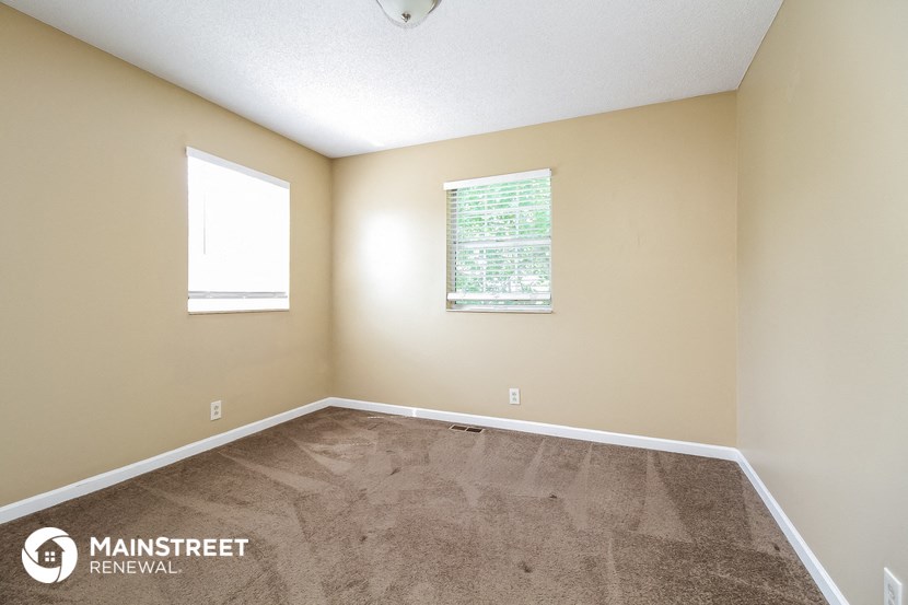 the interior of a room with carpet and a window