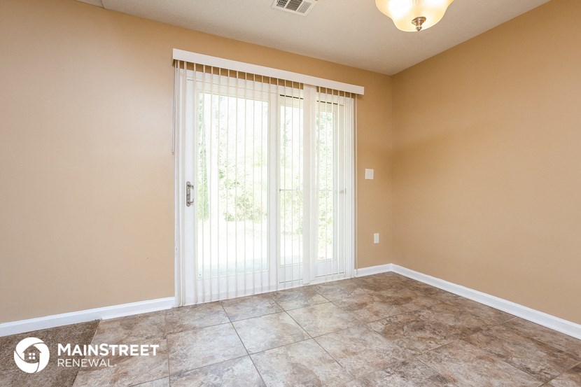 the living room of a new home with sliding glass doors