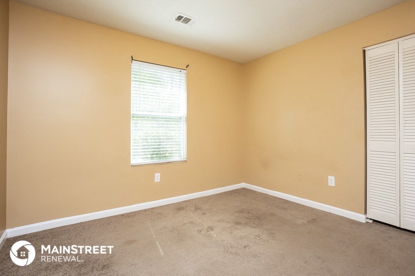 a large room with a window and a carpet