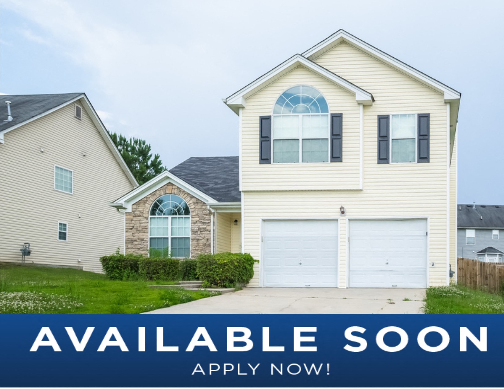 a white house with a garage and a sign that reads available soon