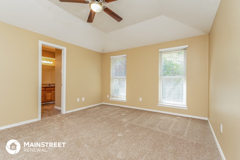 the master bedroom is spacious and has a ceiling fan