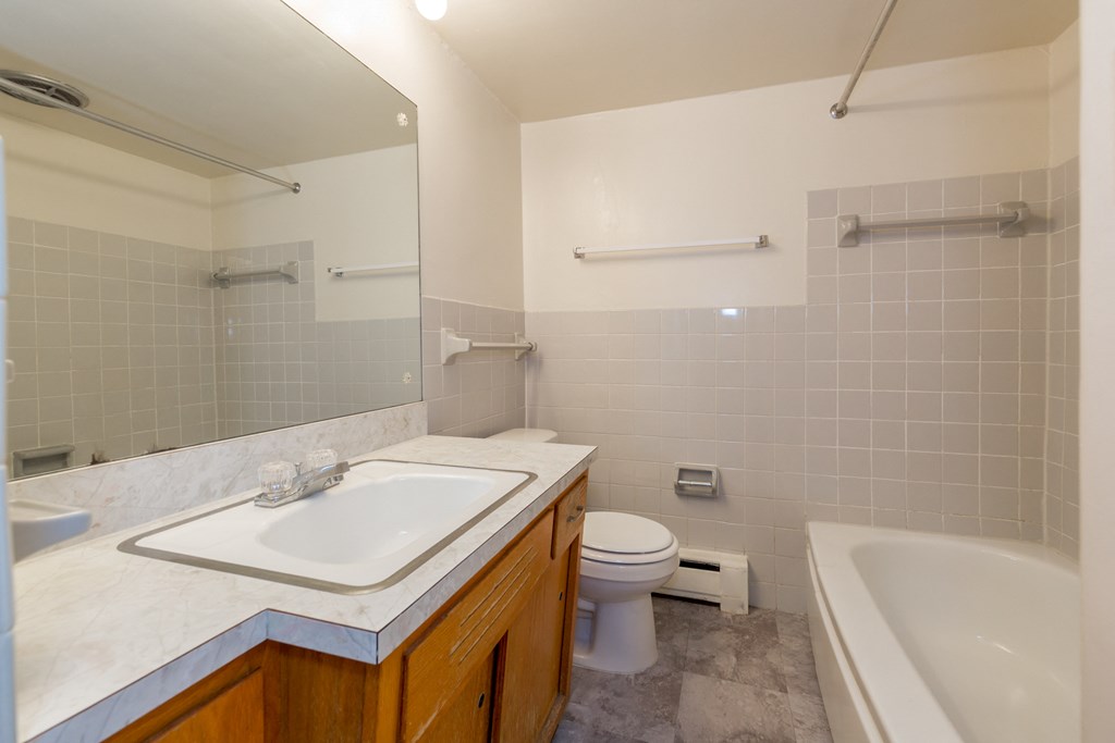 a bathroom with a sink toilet and a bath tub