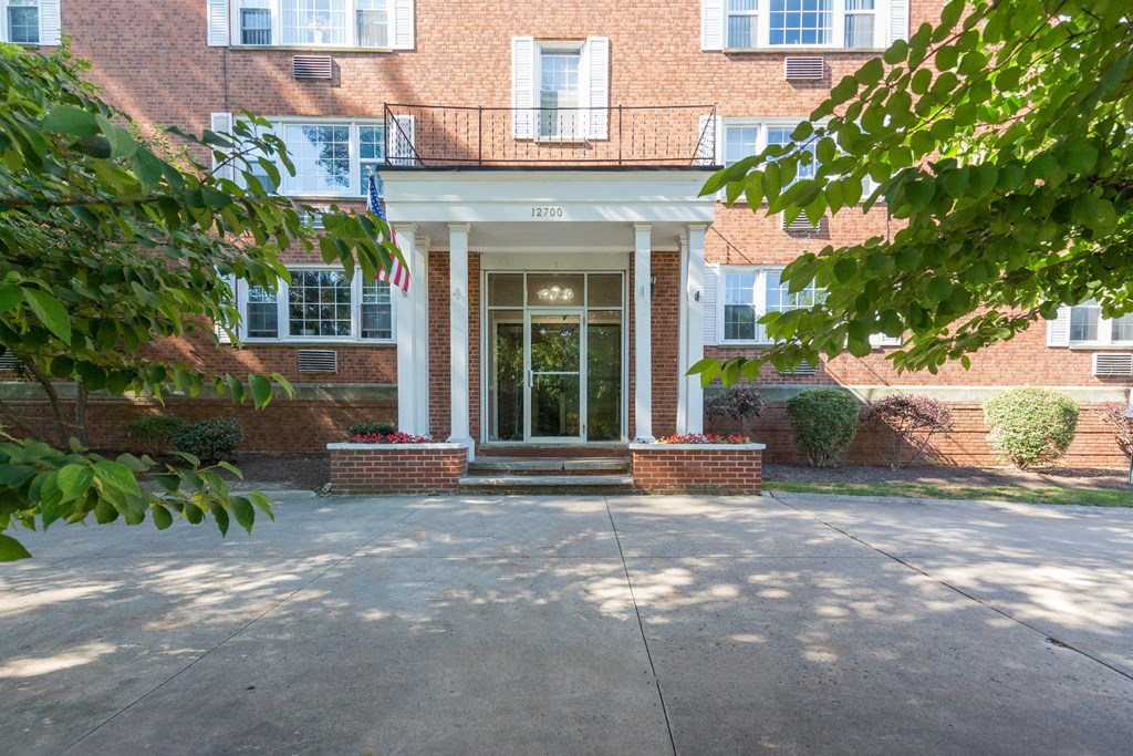 the front of a brick building with a glass door