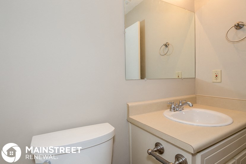 a bathroom with a sink and a toilet and a mirror