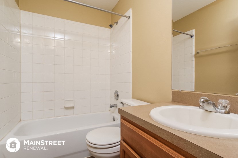 a bathroom with a sink and a tub and a toilet