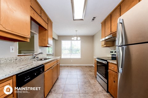 a kitchen with wooden cabinets and stainless steel appliances