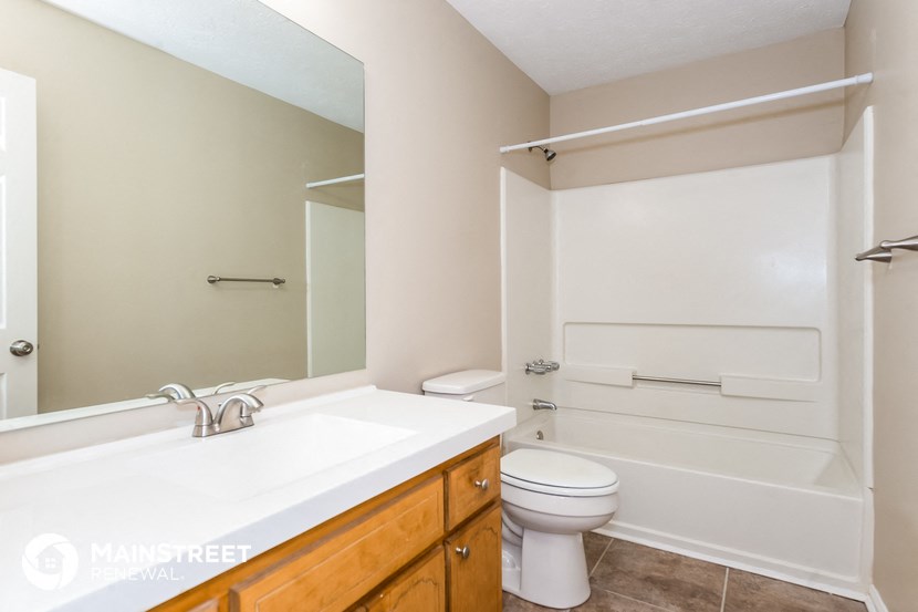 a bathroom with a sink and a toilet and a bath tub