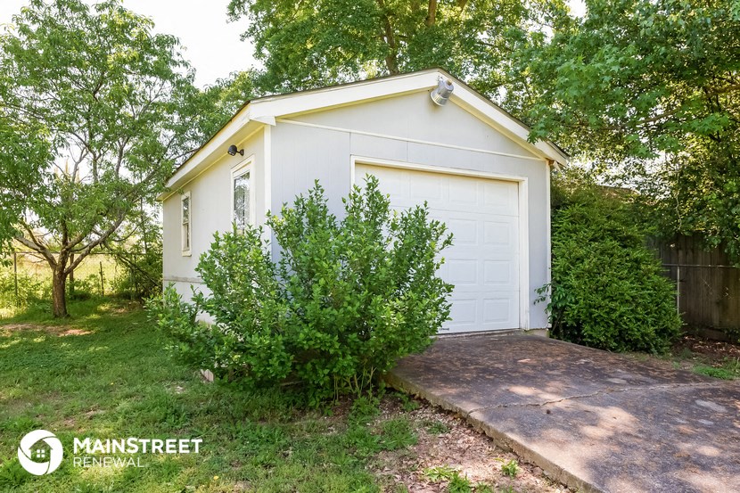 a small white garage with a white garage door