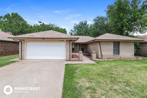 a white brick house with a white garage door