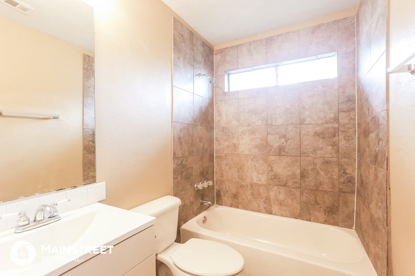 a bathroom with a tub and a toilet and a sink
