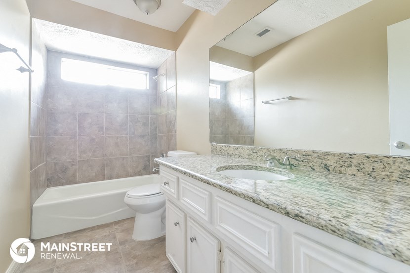 a bathroom with a sink and a toilet and a bath tub