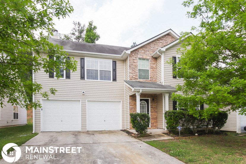 a white house with a white garage door
