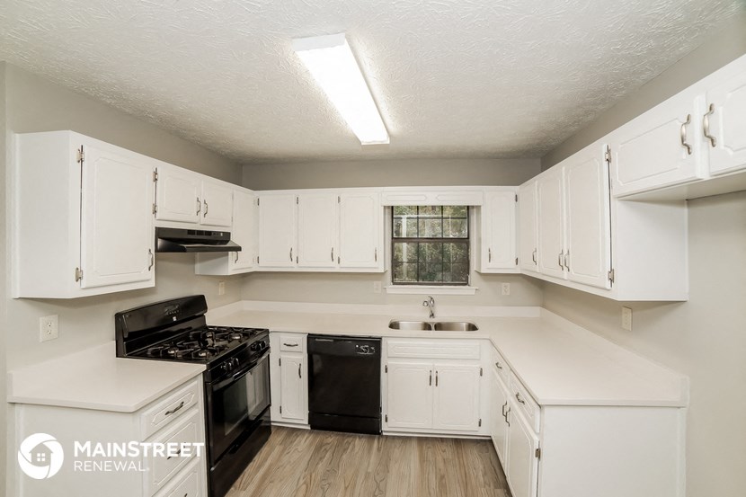 the preserve at ballantyne commons apartment kitchen with white cabinets and black appliances