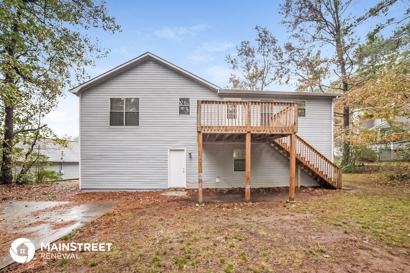 the back of a house with a deck and a porch