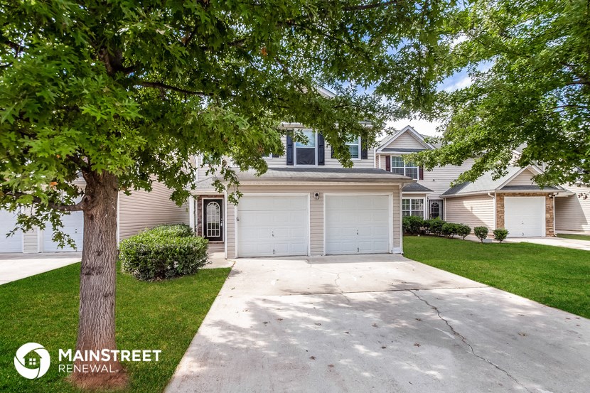 a white garage door in front of a house