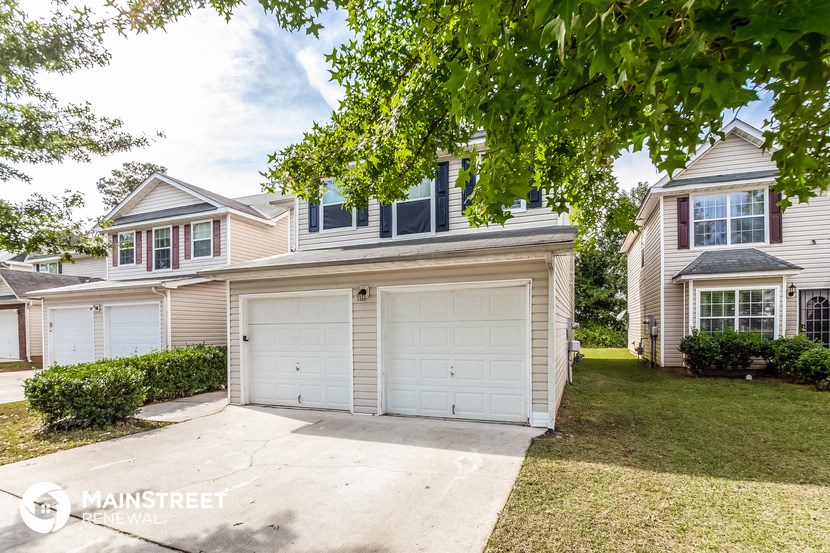 a house with a white garage door and a lawn
