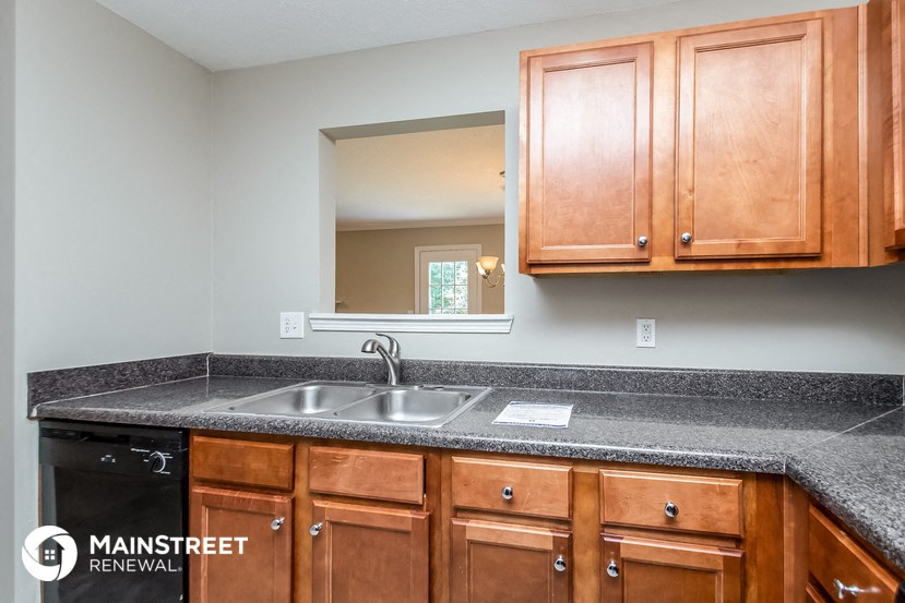 the kitchen has granite counter tops and wood cabinets