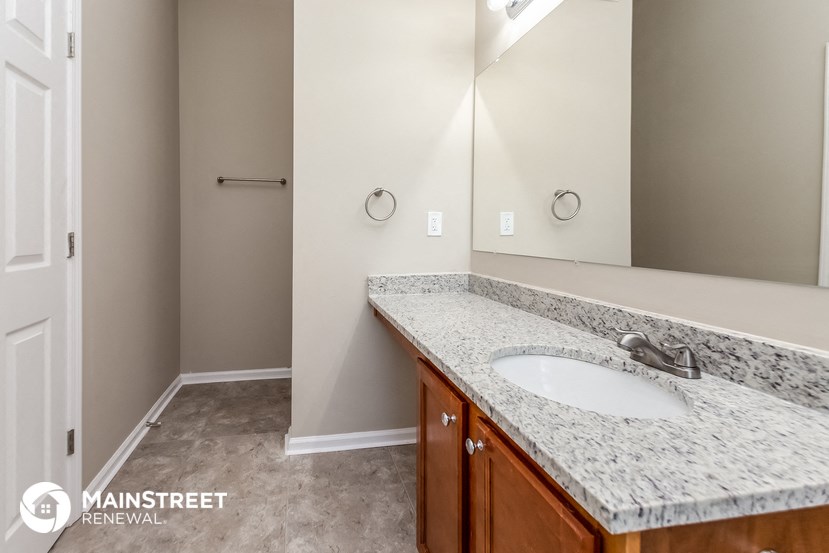 a bathroom with a sink and a large mirror