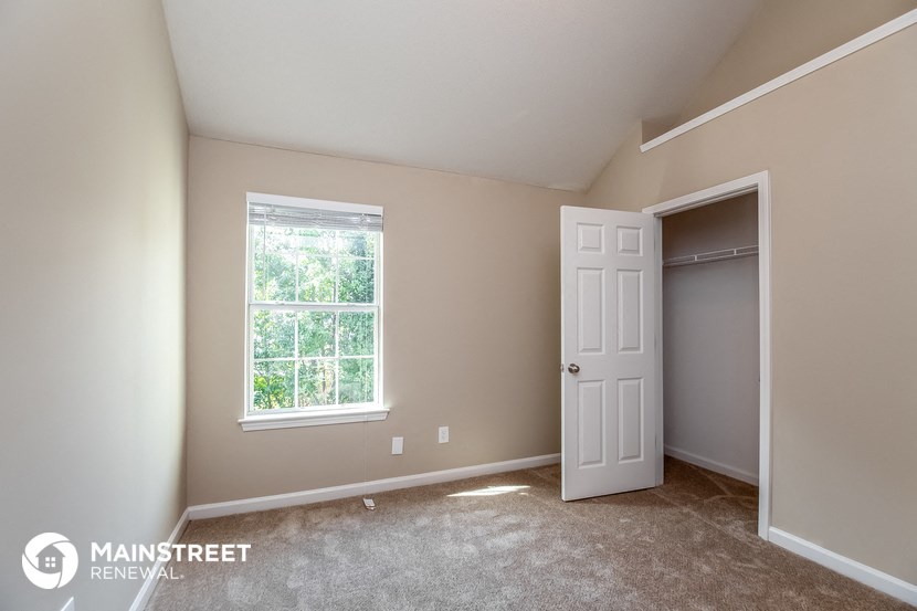 the master bedroom is spacious and has a closet and a window