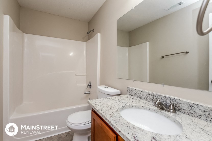 a bathroom with a sink and a toilet and a shower