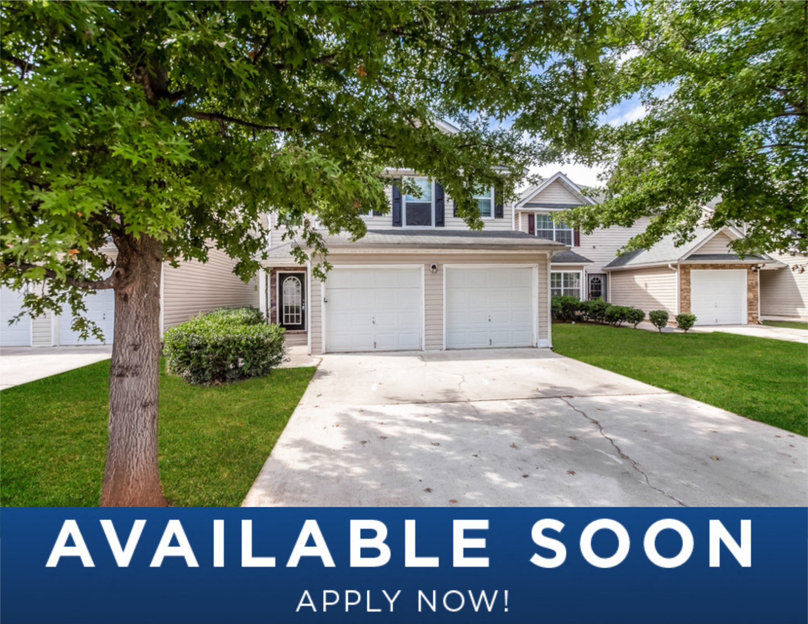 a home with a white garage door and a driveway
