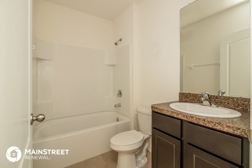 a bathroom with a sink toilet and a bath tub
