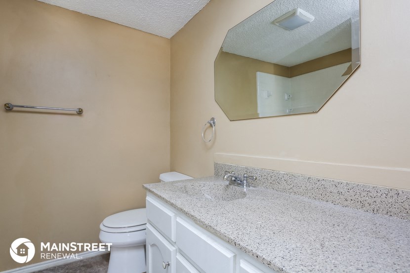 a bathroom with a sink and a toilet and a mirror