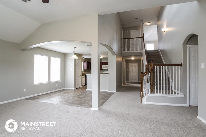 the living room and staircase of a new home