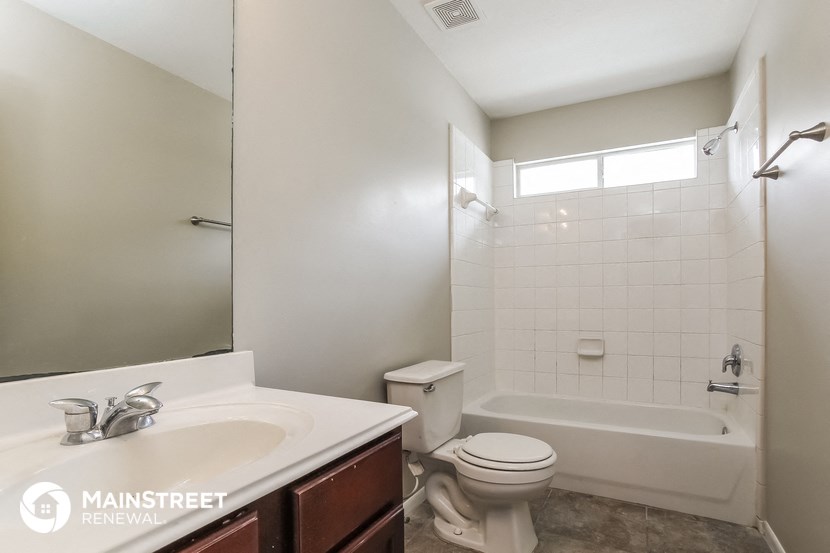 a bathroom with a shower toilet and sink and a mirror