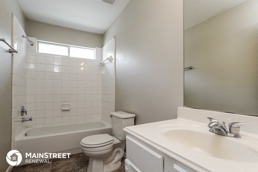 a white bathroom with a sink toilet and shower