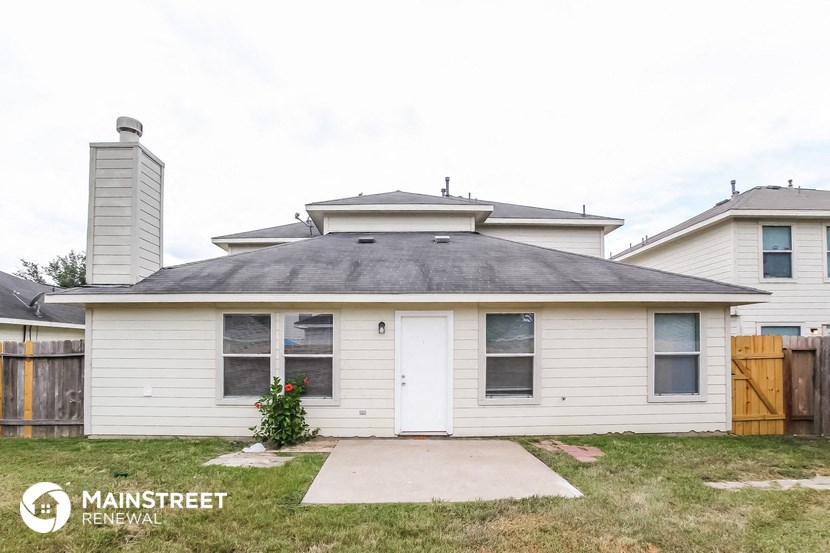 the front of a white house with a gray roof